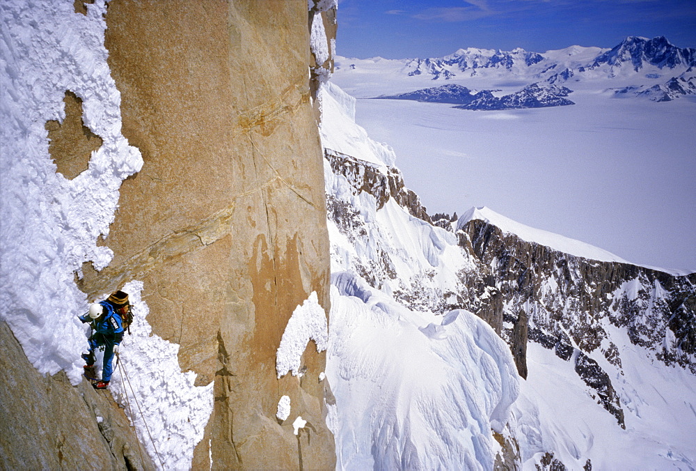 A mountaineer climbs Cerro Torre's northwest face, with the southern Continental Icecap in the background, in Argentine Patagonia. Cerro Torre is one of the most difficult and iconic peaks in the Southern Andes, and is a highly sought after summit by the worlds top alpinists, Argentina