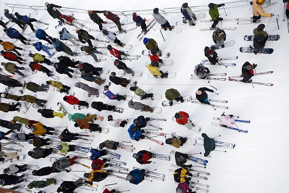 Aerial view of skiers and snowboarders standing in lift line at Mount Hood Meadows ski resort in Oregon Cascades, United States of America