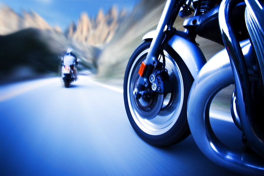 Two motorcycles weave through windy mountain roads, United States of America