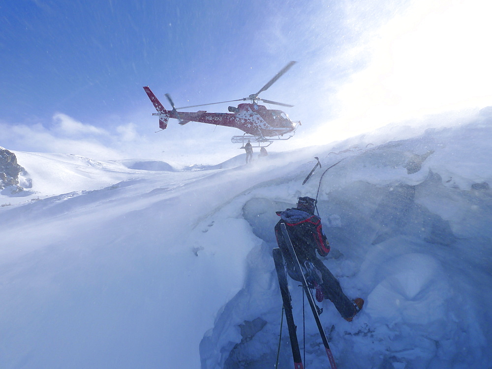 A mountain rescue technician is descending into a crevasse. When a skier breaks through the snow and tumbles down the glacier, the only way out is being winched out by the rescuers of Air Zermatt.