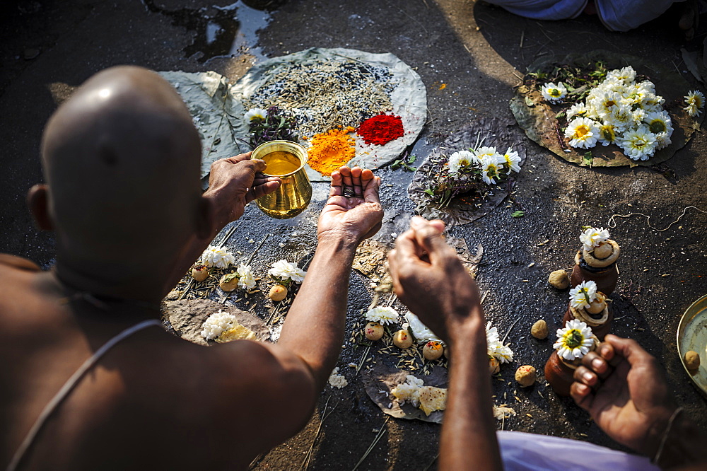 Performing a ceremony for the deceased family members at the Godavari river, Nashik, Maharashtra, India.