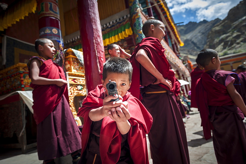 Young monks playing with plastic guns during Hemis Festival, Ladakh, India.