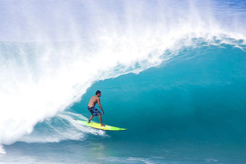 man surfing a large wave at Pipeline, on the north shore of Oahu, Hawaii ,