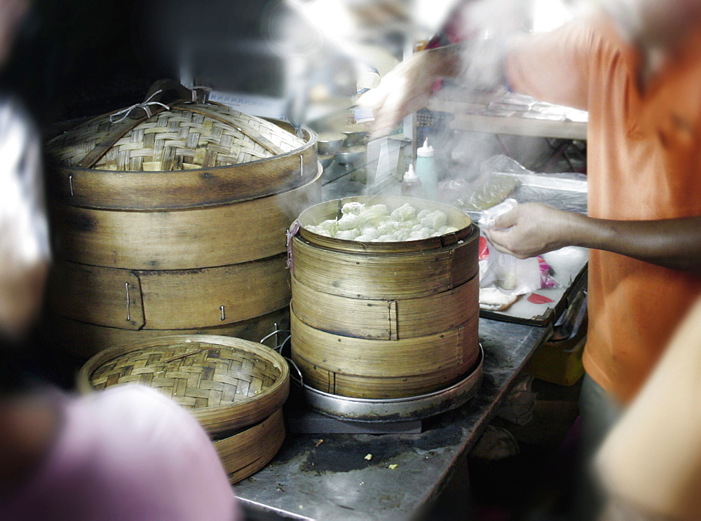 A street vendor sells dim sum at a night market known as Pasar Malam to the locals in Kuala Lumpur, Malaysia.