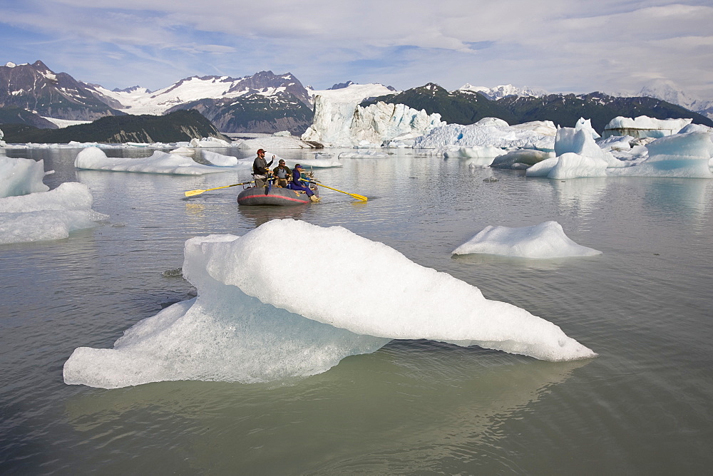 Raft negotiating icebergs in a lake in Alaska, United States.