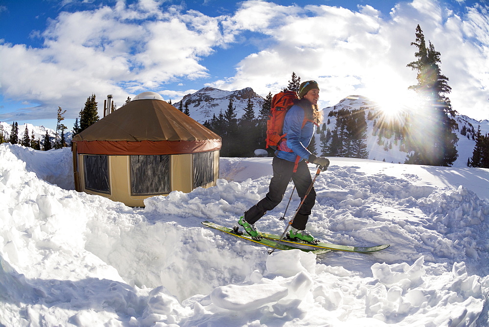 A woman backcountry skiing on Red Mountain Pass, Silverton, Colorado.