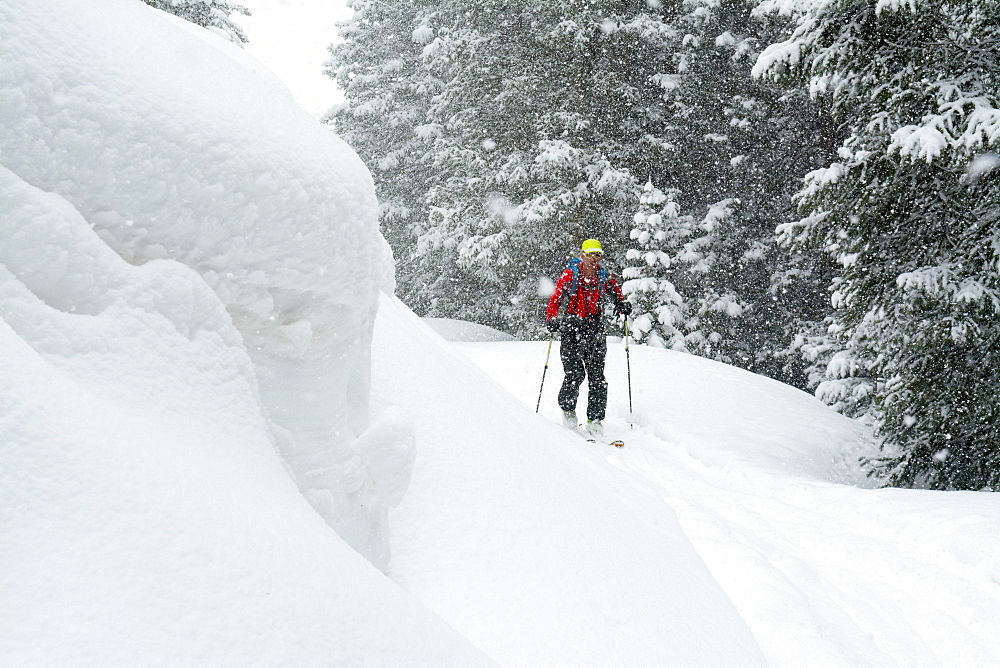 A man backcountry skiing  above Red Mountain Pass, Silverton, Colorado.