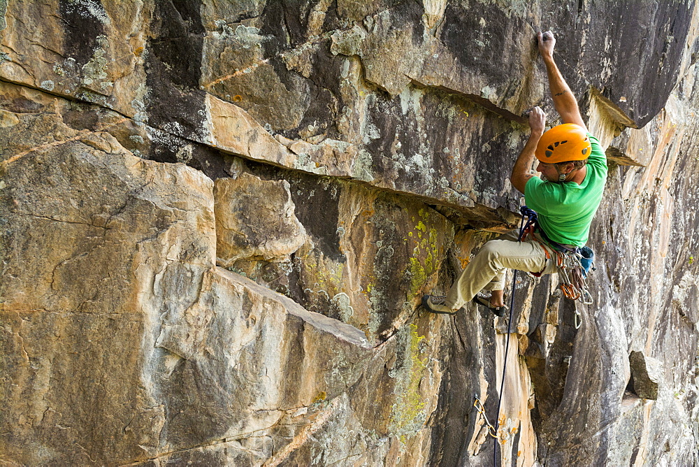 A man holding onto very small edges while rock climbing at the Lost Crag, San Juan National Forest,Vallecito, Colorado.