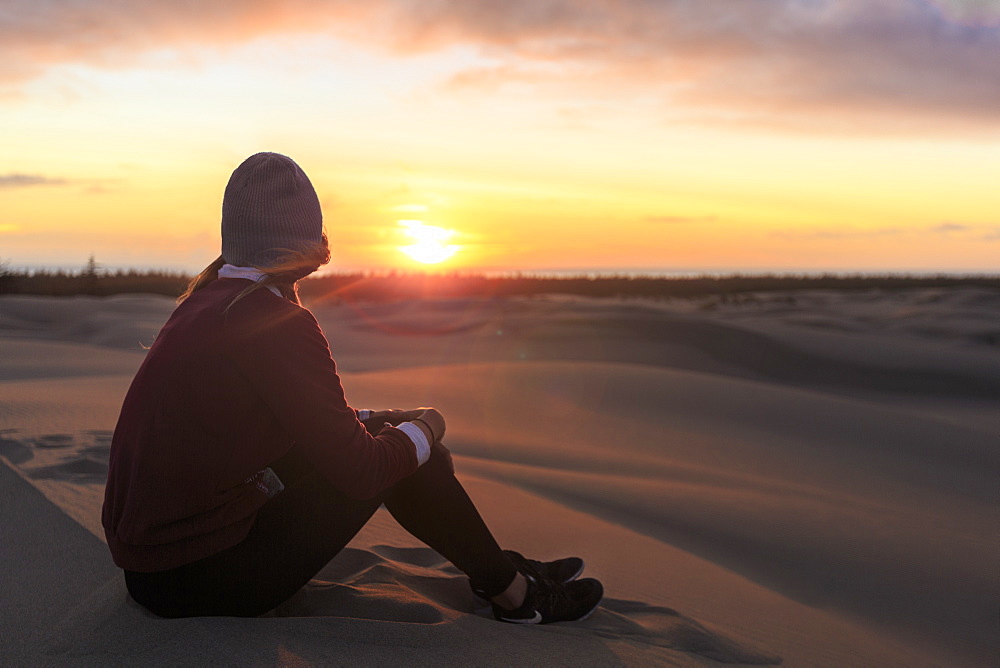 Woman watches sunset