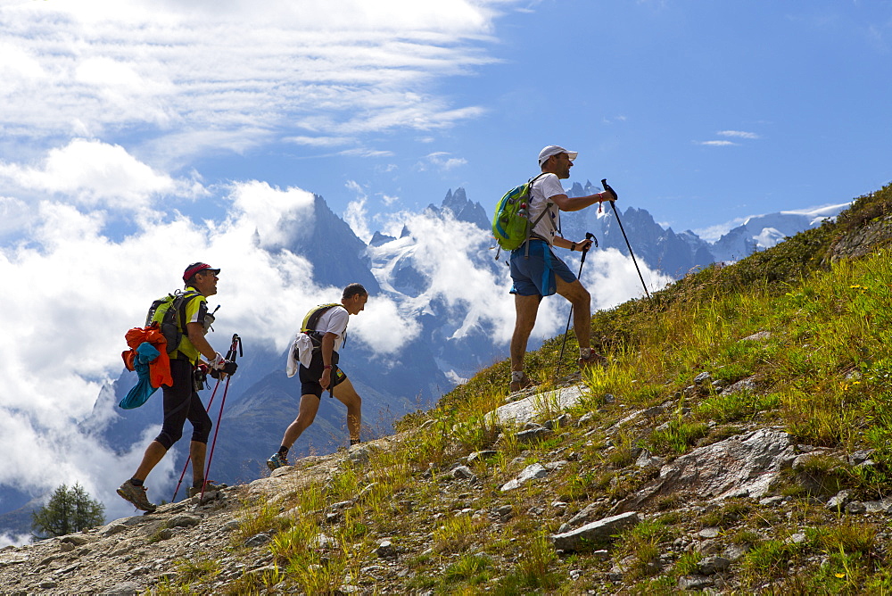 Three participants of the UTMB are running in the hills of Chamonix. The famous peaks of the Mont Blanc range are in the background. The Ultra-Trail du Mont-Blanc (also referred to as UTMB) is a single-stage mountain ultramarathon. It takes place once a year in the Alps, across France, Italy and Switzerland. The distance is approximately 166 kilometres (103 mi), with a total elevation gain of around 9,600 m. It is widely regarded as one of the most difficult foot races in Europe. It's certainly one of the largest with over two thousand starters. The combined participation in all of the events is approaching 10 thousand runners. While the best runners complete the loop in slightly more than 20 hours, most runners take 30 to 45 hours to reach the finish line.