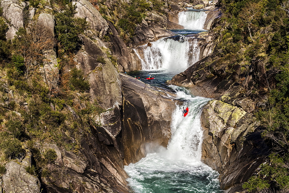 Spanish whitewater kayaker Aniol Serrasolses is dropping down the last waterfall of a triple set on the Rio Castro Laboreiro.