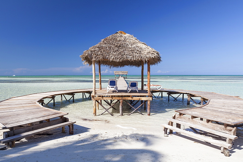 Wooden jetty entering turquoise water with no people in Cayo Guillermo, Cuba