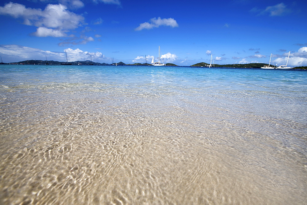 Crystal clear Caribbean water and bright blue skies provide a perfect scene with sailboats moored off of Honeymoon Beach, St. John, USVI.