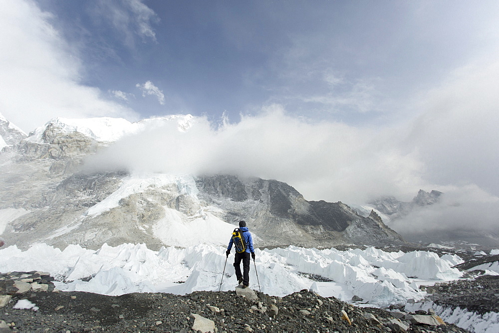 A trekker stands over the Khumbu Glacier in Everest Base Camp.