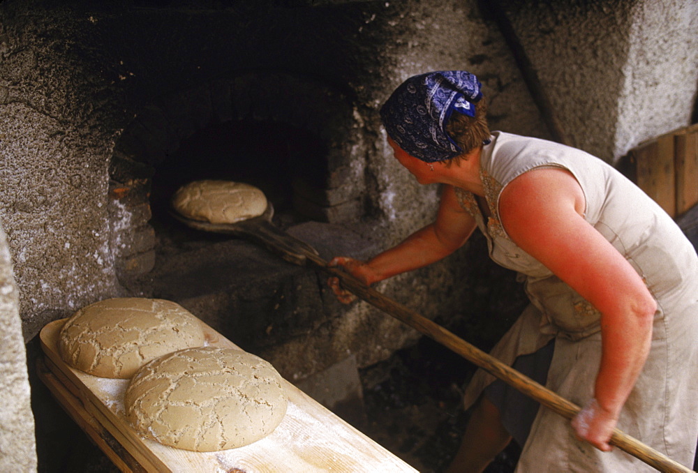 Cooking bread in an outside oven.