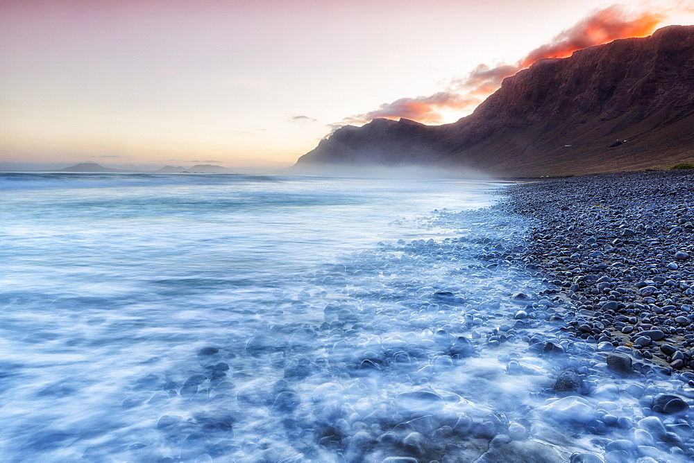 Playa de Famara risco de famara beach Mountain sand rocks reflection Lanzarote Canary Islands Spain