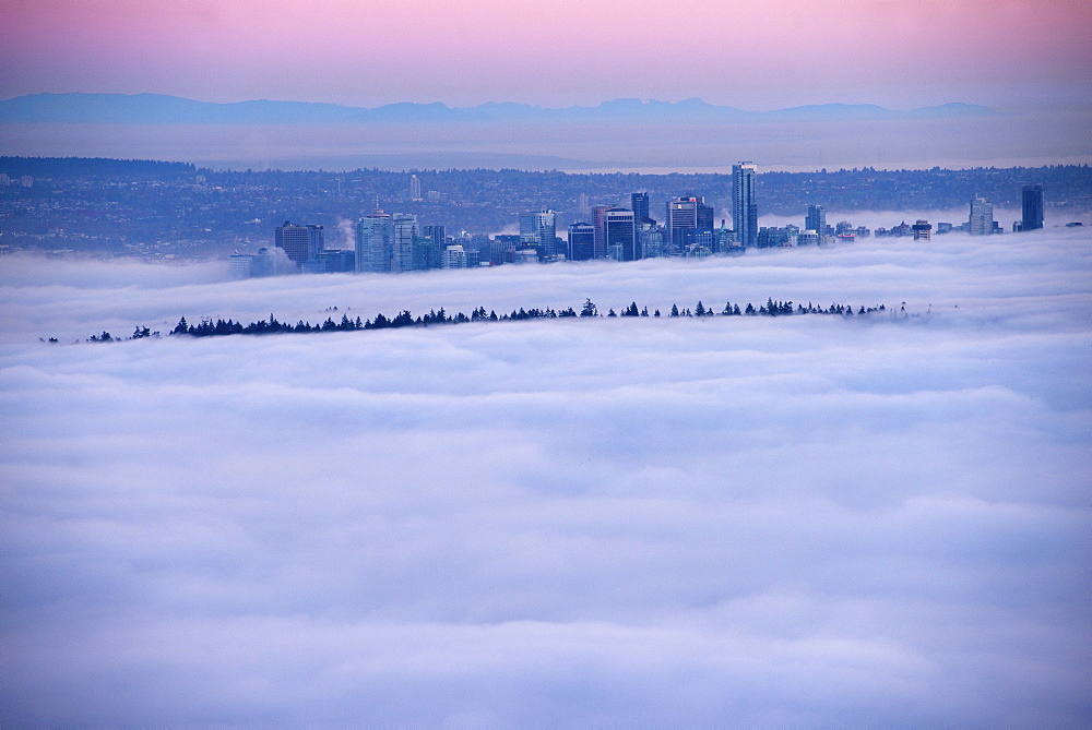 Fog inversion over downtown Vancouver and Stanley Park. Vancouver, British Columbia