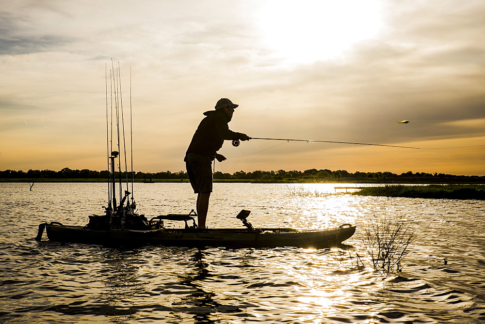 Guillermo casts at sunrise in east texas