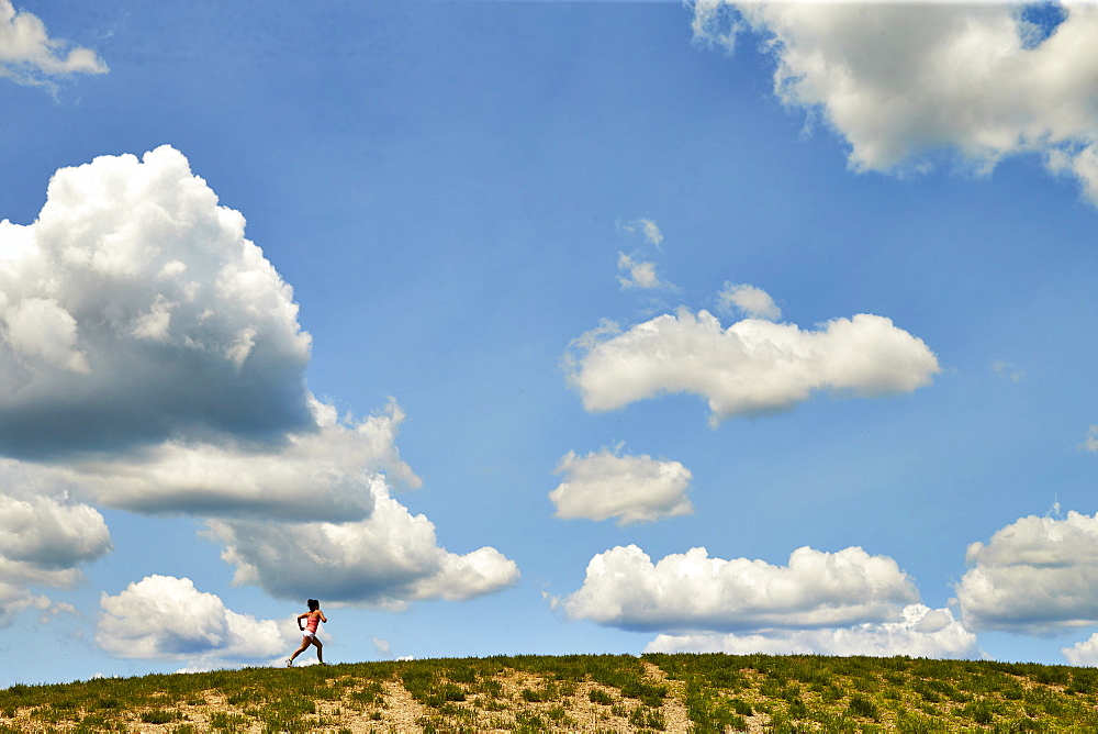 Long Exposure Of Woman Running Along The Horizon