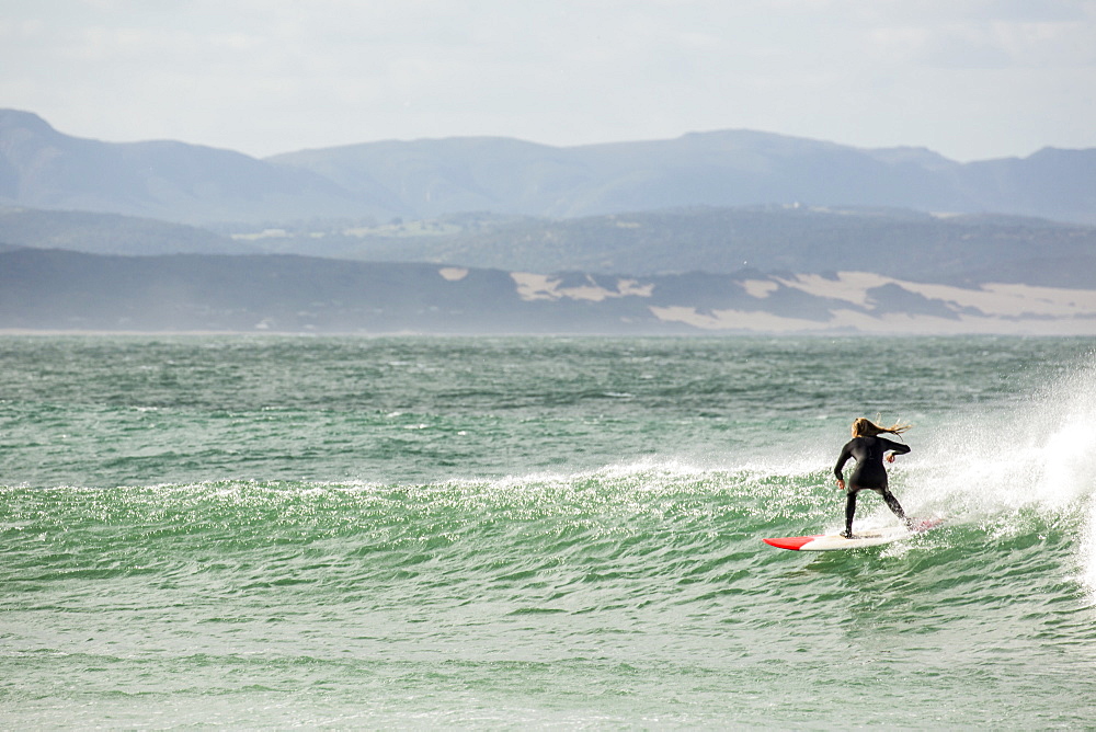 A talented girl surfing at Jefferys Bay, South Africa