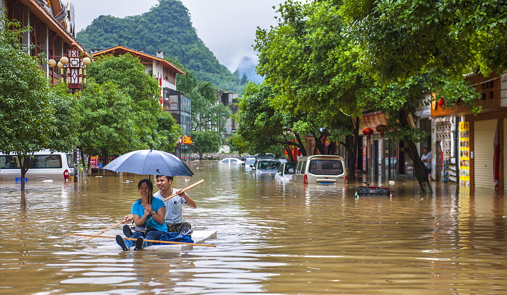 Couple Floating On A Raft During The Floods In Yangshuo