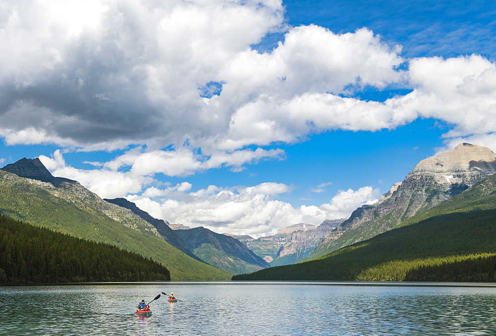 Two Kayakers Kayaking On Bowman Lake In Glacier National Park