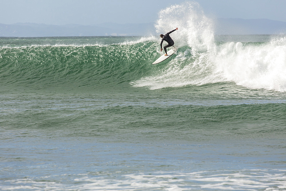 A Male Surfer Surfing On A Big Wave At Jeffery's Bay