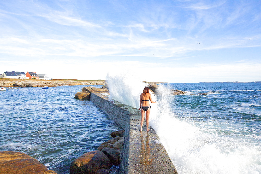 Woman Walking On Rock With Splashing Water In Ile De Croix, France