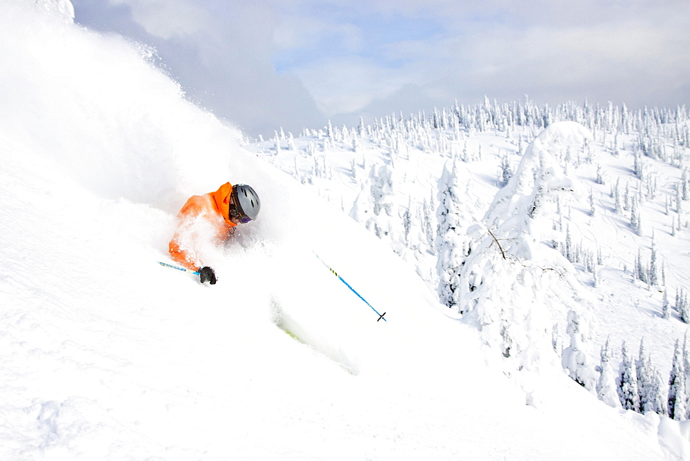 Male Skier Makes A Deep Powder Turn In Snowy Landscape At Whitefish, Montana, Usa