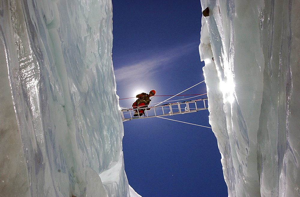 Ngawang Sherpa crosses a massive crevasse on a ladder