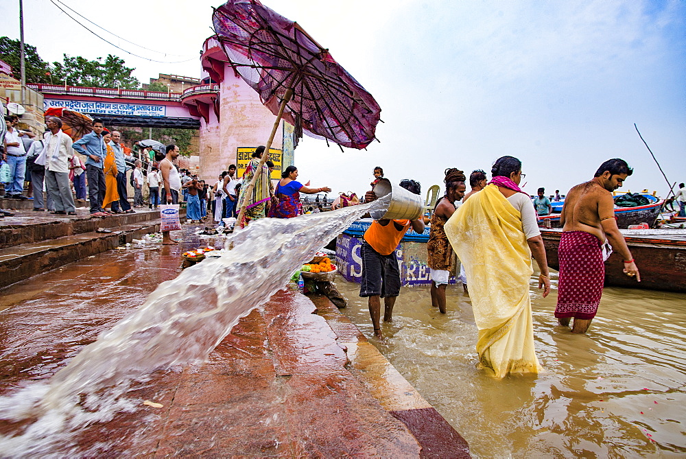 A worker cleans the stone steps leading into the Ganges River at Dr Rajendra Prasad Ghat, Varanasi, Uttar Pradesh, India