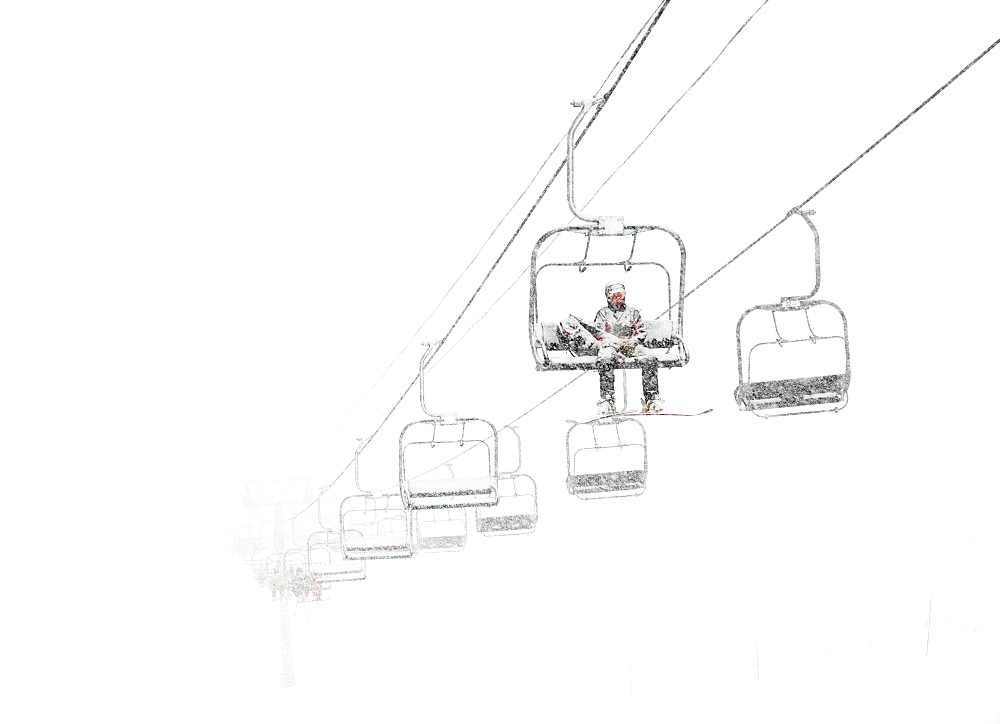 A Lone Ski Patroller Sitting On A Ski Lift In White Out Conditions At Arapahoe Basin Ski Resort