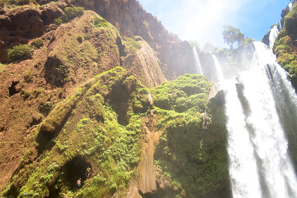 Two Boys Getting Ready To Jump From High Above The Water Next To Cascades Douzoud Waterfall