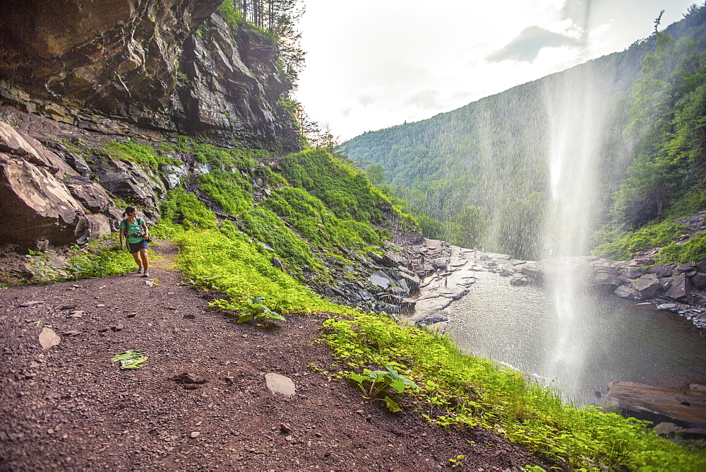 Hiker Walking Under The Kaaterskill Waterfalls, New York, Usa