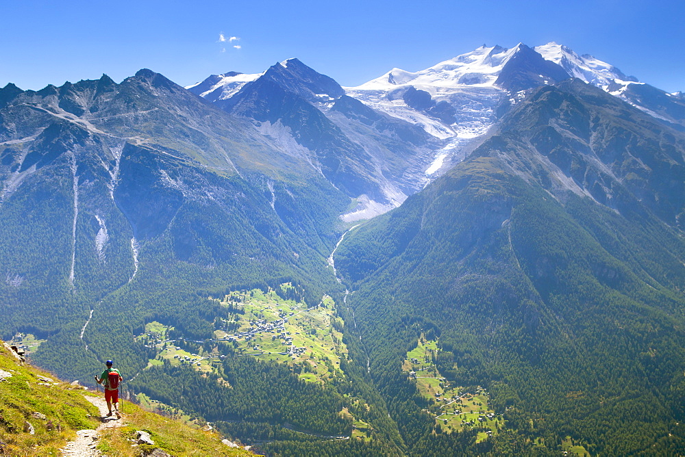 A Hiker Descending From The Augstbordpass Into The Matterhorn Valley