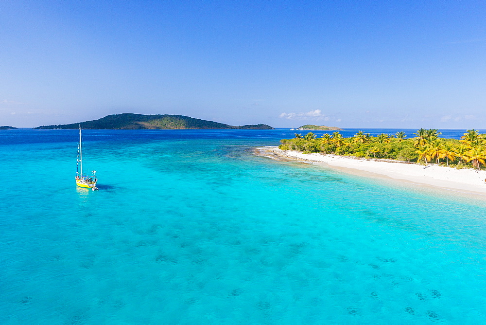 A Sailboat Moored Off An Uninhabited Islet Of The British Virgin Islands In The Caribbean