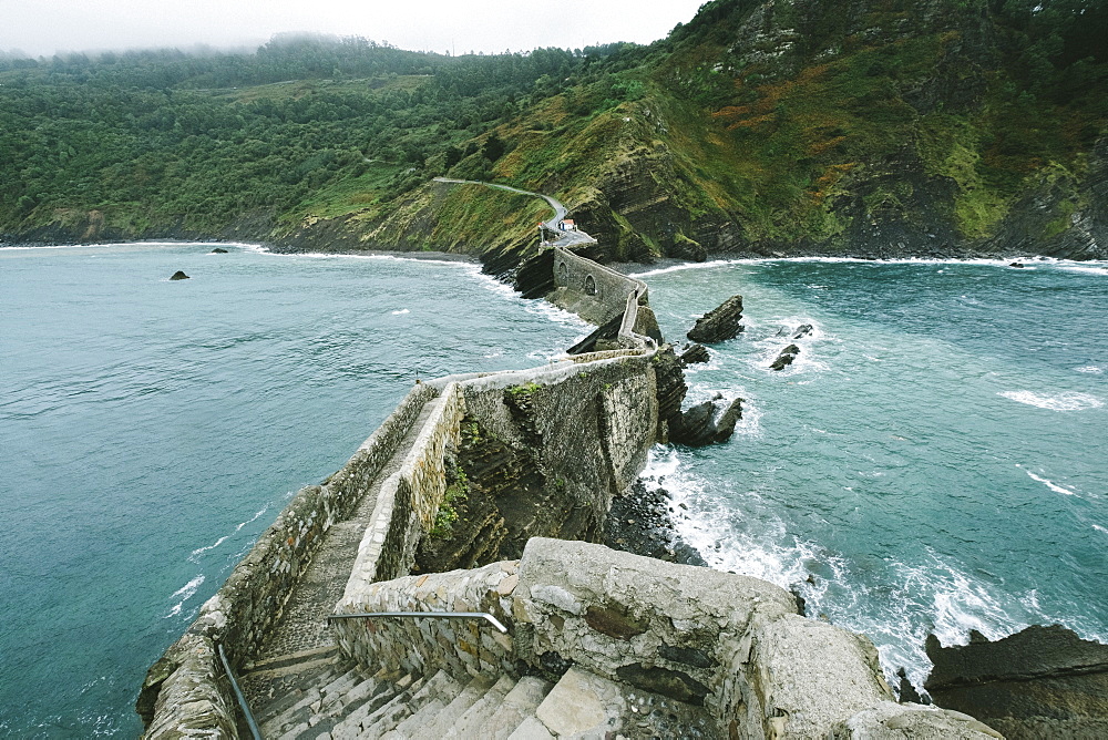 View Of The Islet Of Gaztelugatxe Connected To The Mainland By A Man-made Bridge