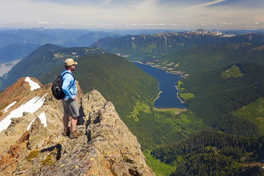 Hiker looking down on Jones Lake from top of Lady Peak in Cheam Mountain Range