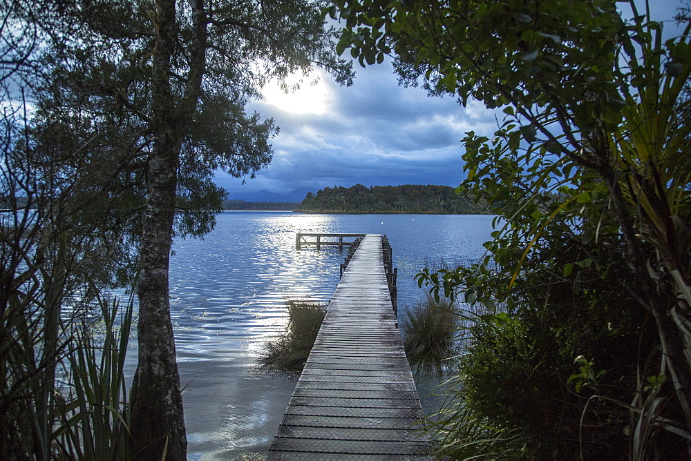 Wooden Dock On Lake During Sunset