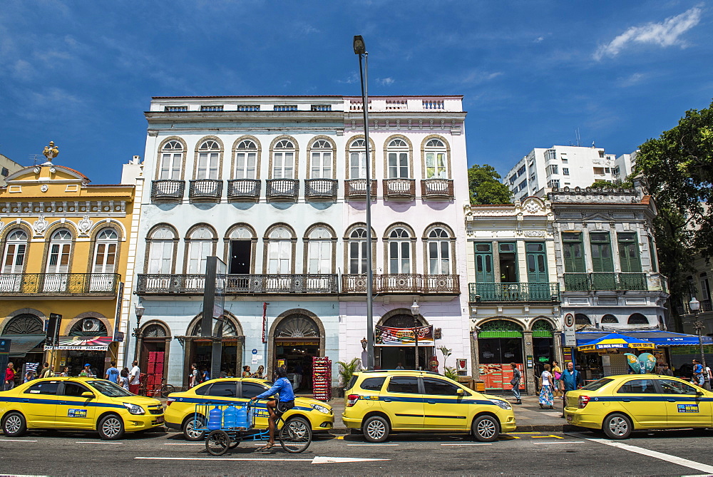 Old historical houses and Iconic yellow taxi in Rua do Catete street, Rio de Janeiro, Brazil