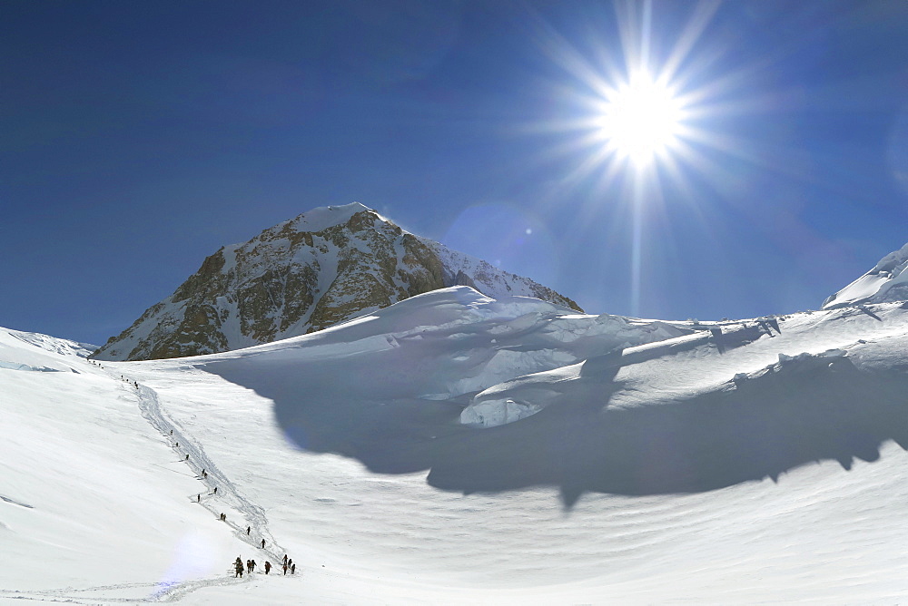 Mountaineers Are At The Base Of A Steep Wall On Denali, Alaska