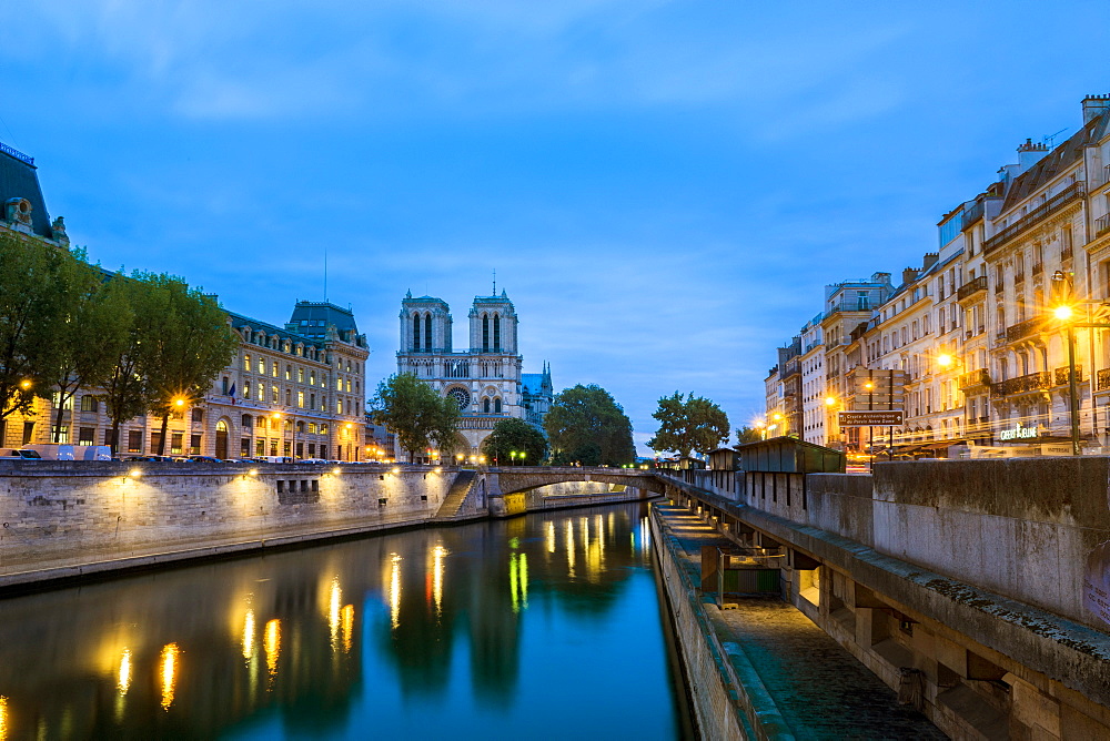 Seine River at dawn with Notre Dame Cathedral in the distance, in the neighborhood of Saint-Michel, Paris, France
