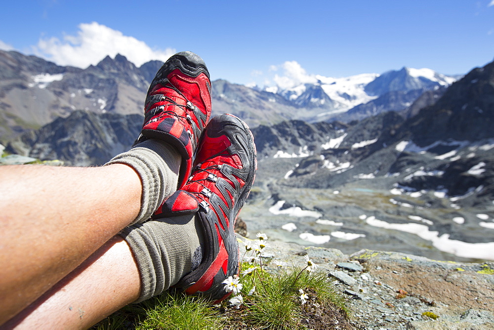 Trail running shoes are resting in the mountains of Switzerland. Halfway the Haute Route, a classic multi day hike in Switzerland.