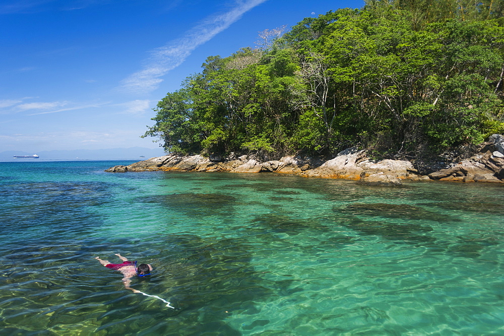 Man swimming in Lagoa Azul (Blue Lagoon) in Ilha Grande, Rio de Janeiro, Brazil