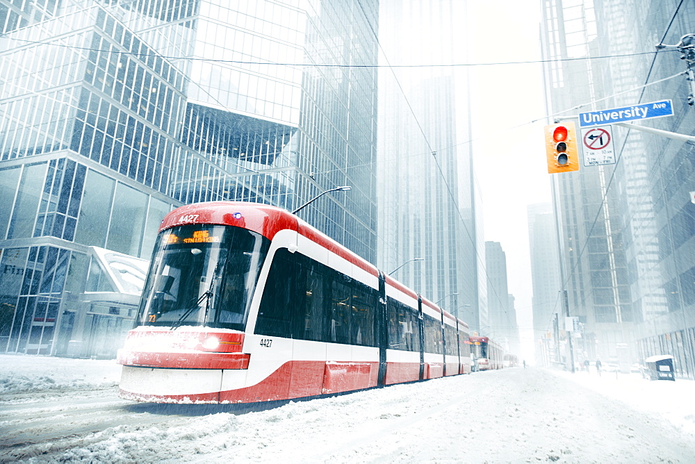 Composition of several street cars on a snowy winter day in Toronto.