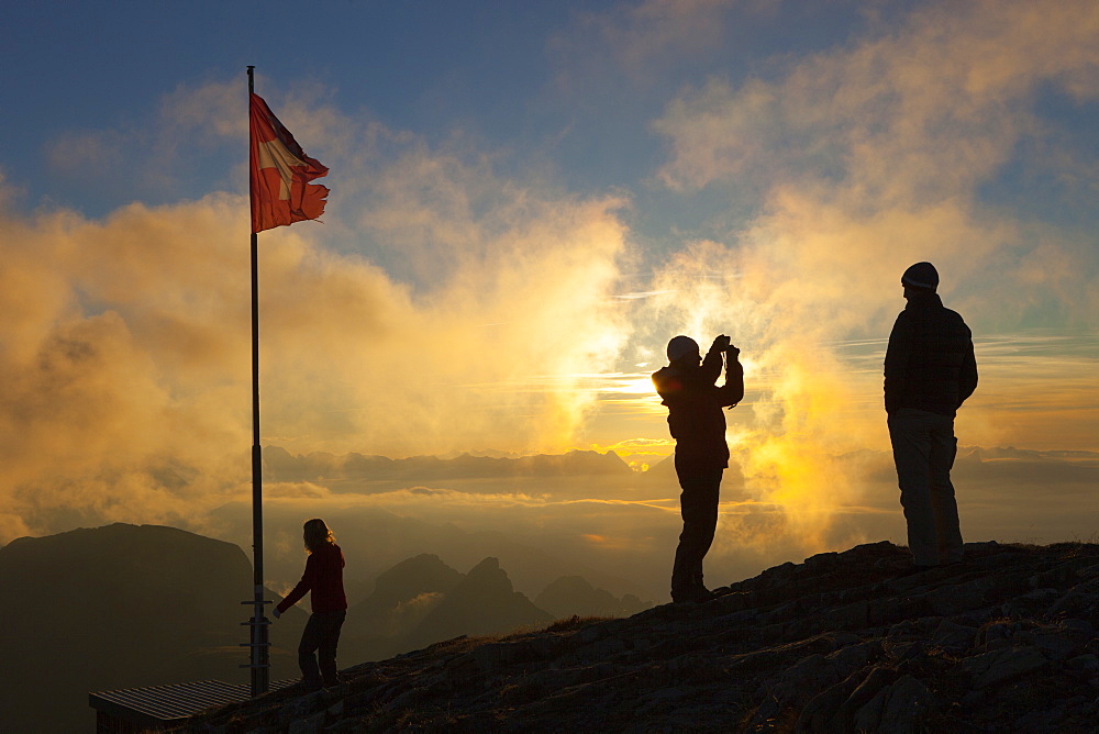 Family of hikers at summit of Faulhorn in Swiss Alps at sunset, Grindelwald, Bernese Oberland, Bern Canton, Switzerland