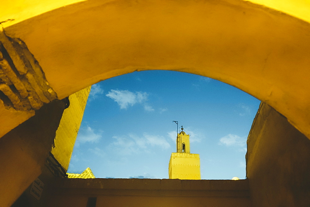 Photograph with Koutoubia Mosque minaret seen through arch, Medina, Marrakech, Morocco