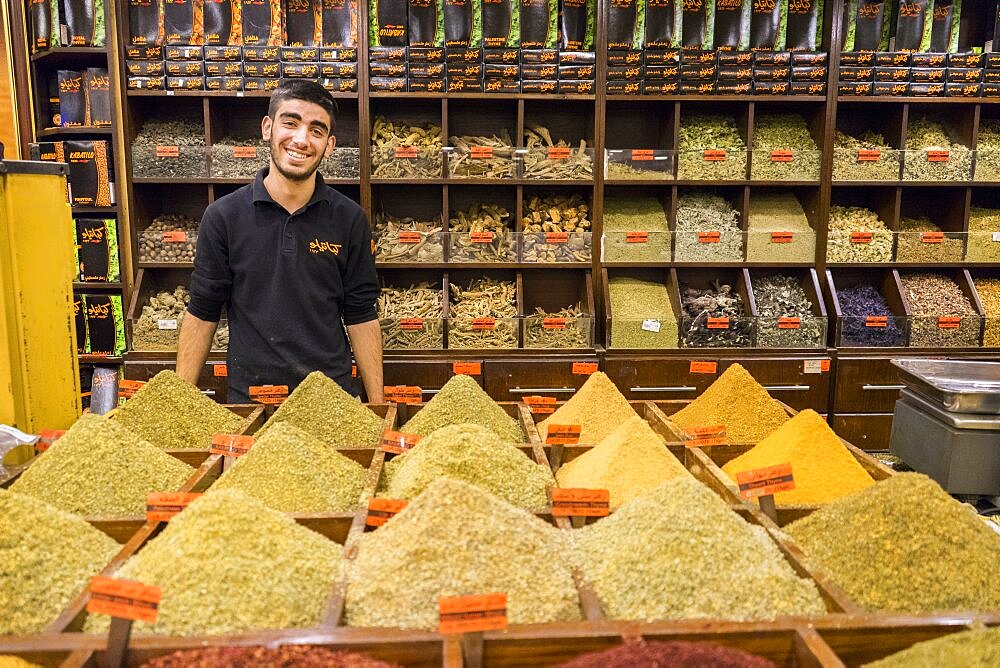 A man sells spices, herbs, nuts and Egyptian duqqa in a Spice Market in Amman, Jordan