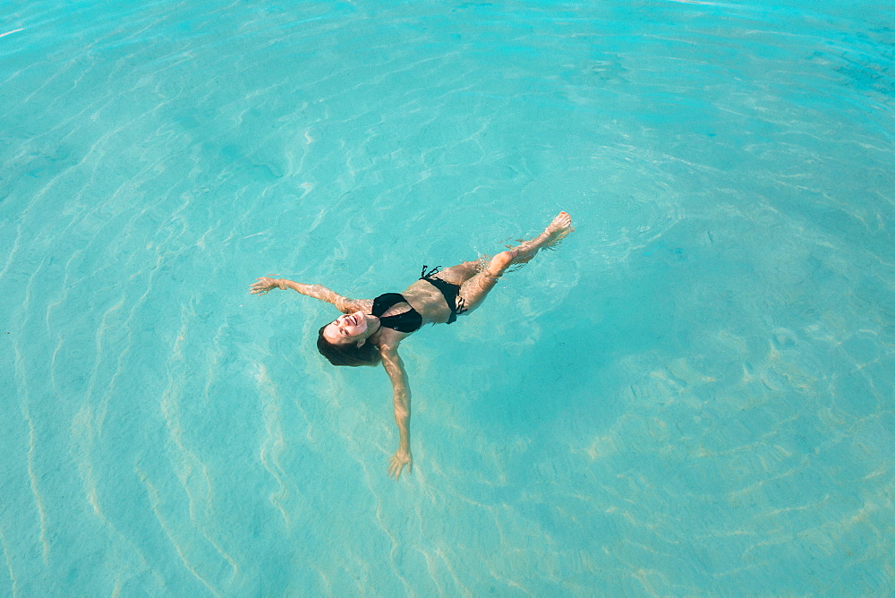 Woman in bikini floating on water, Tambon Ko Tarutao, Chnag Wat Krabi, Thailand