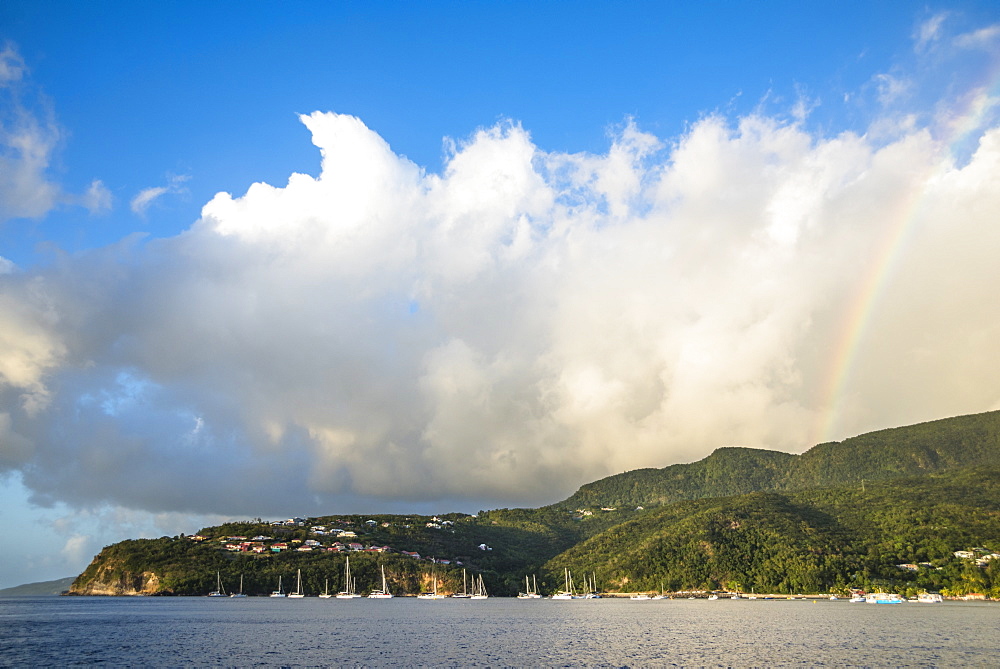 Scenic view of coastline with anchored sailboats with rainbow in background, Bouillante, Basse Terre, Guadeloupe